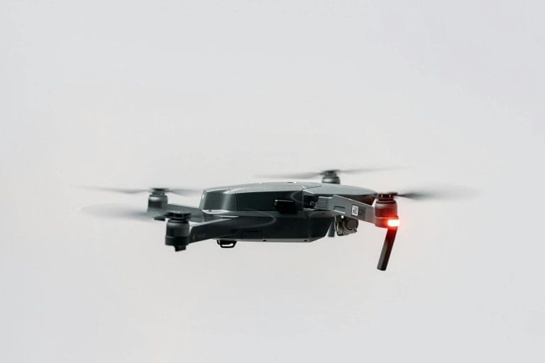 Image of a sleek drone hovering with blurred propellers, showcasing modern technology in action.